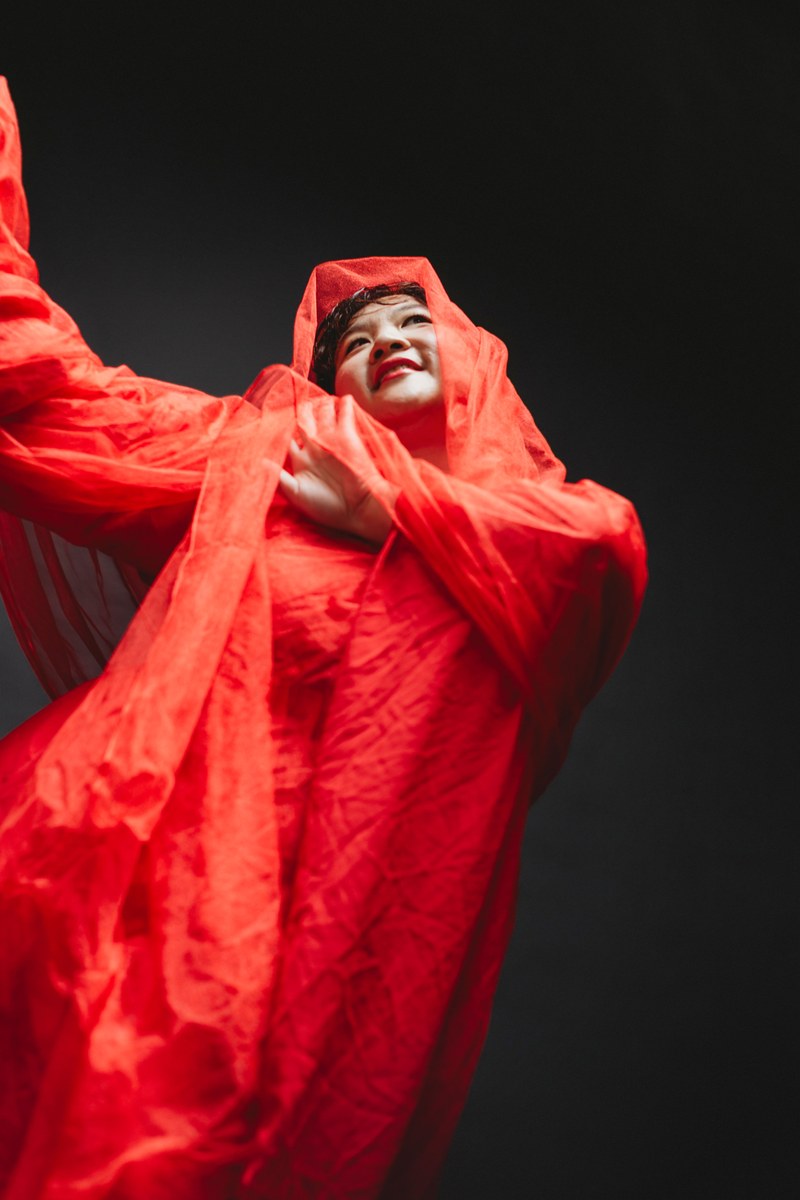 Editorial portrait, red fabric, full length